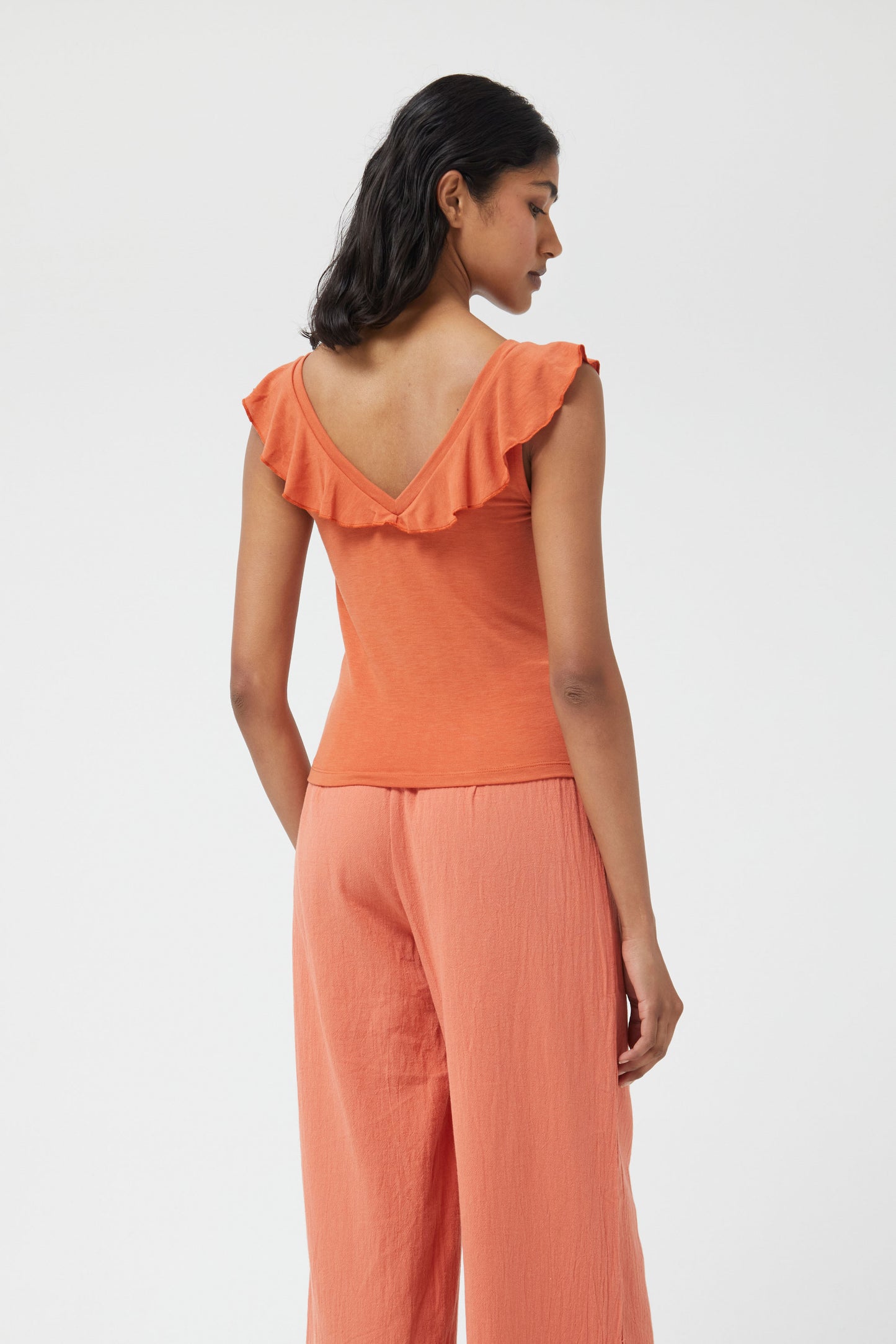 The rust orange stretch plunge style top