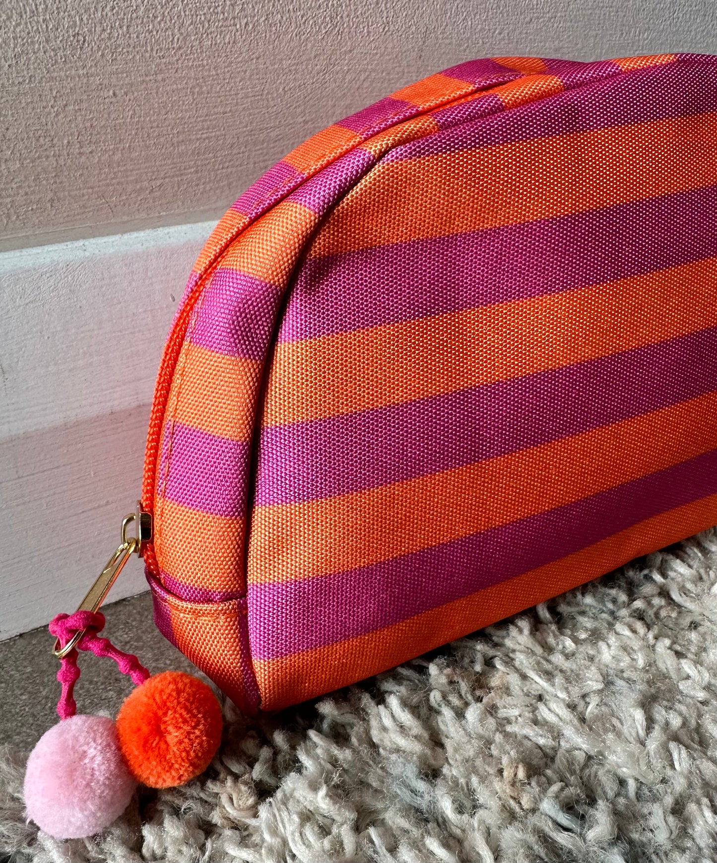 KATE stripe make up bag with Pom Pom detail in pink and orange