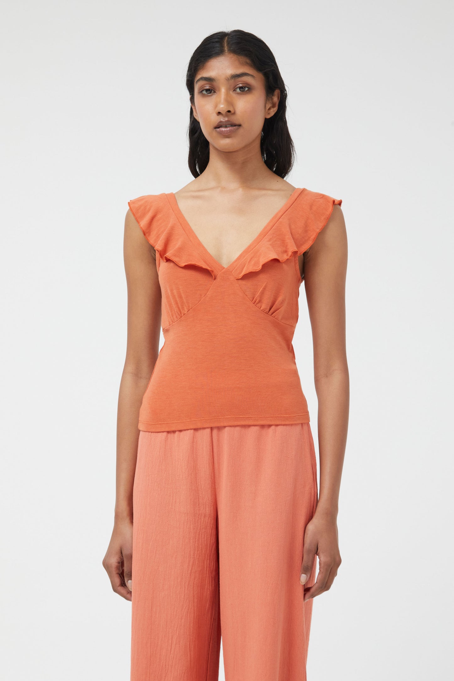 The rust orange stretch plunge style top