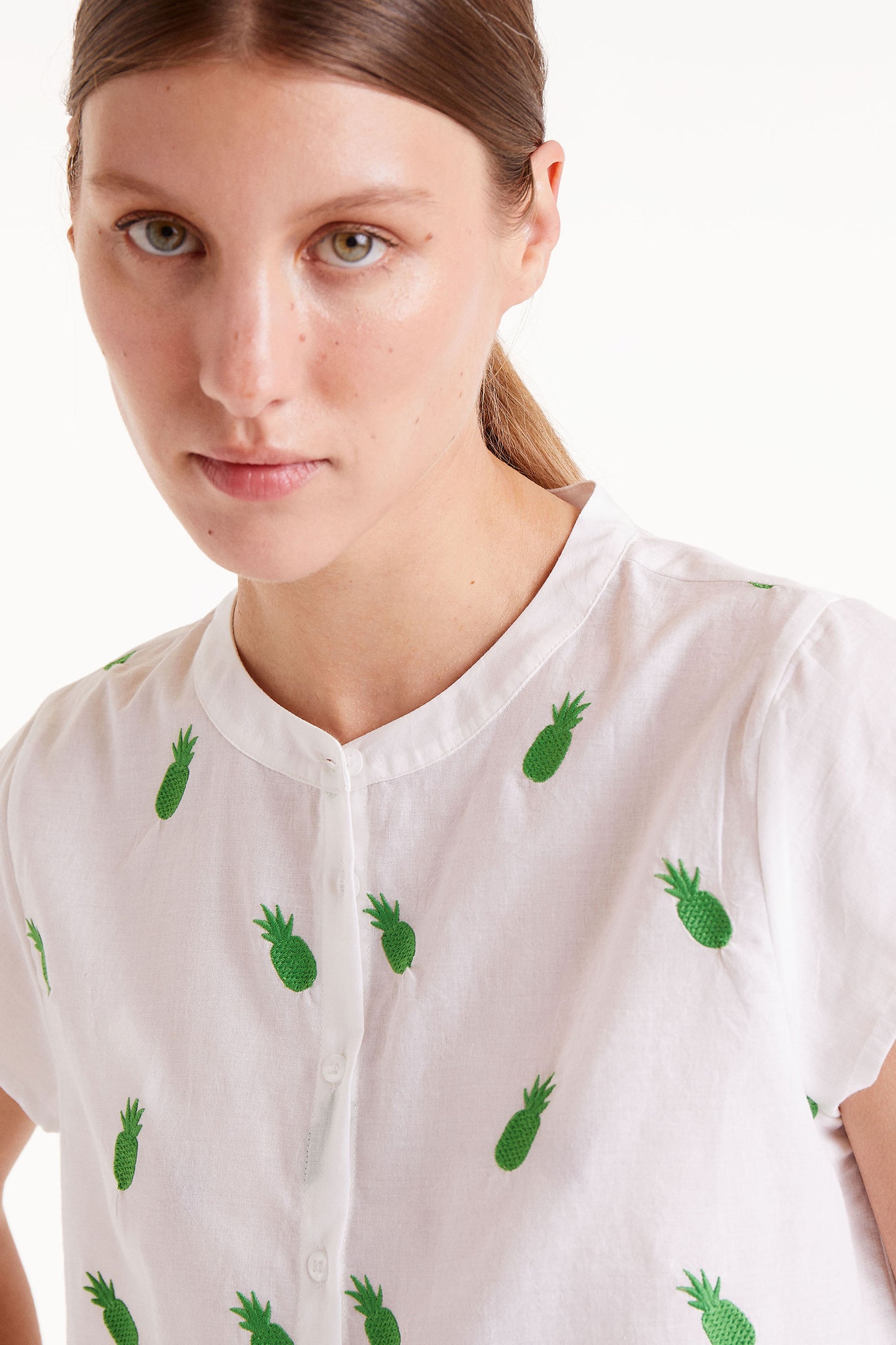 The LOTTIE white shirt with green pineapple embroidery detailing