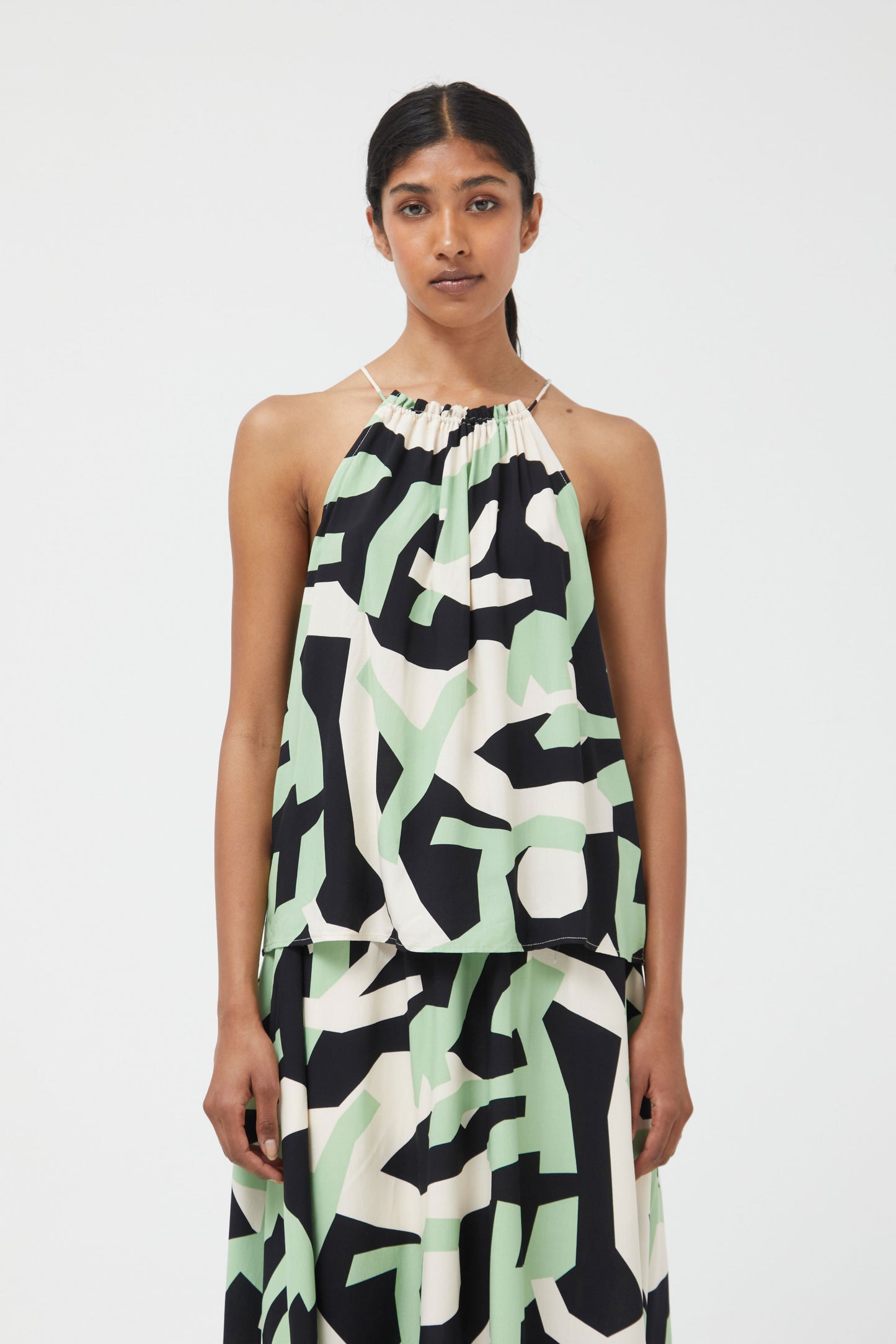 The mint green and black abstract halter neck top