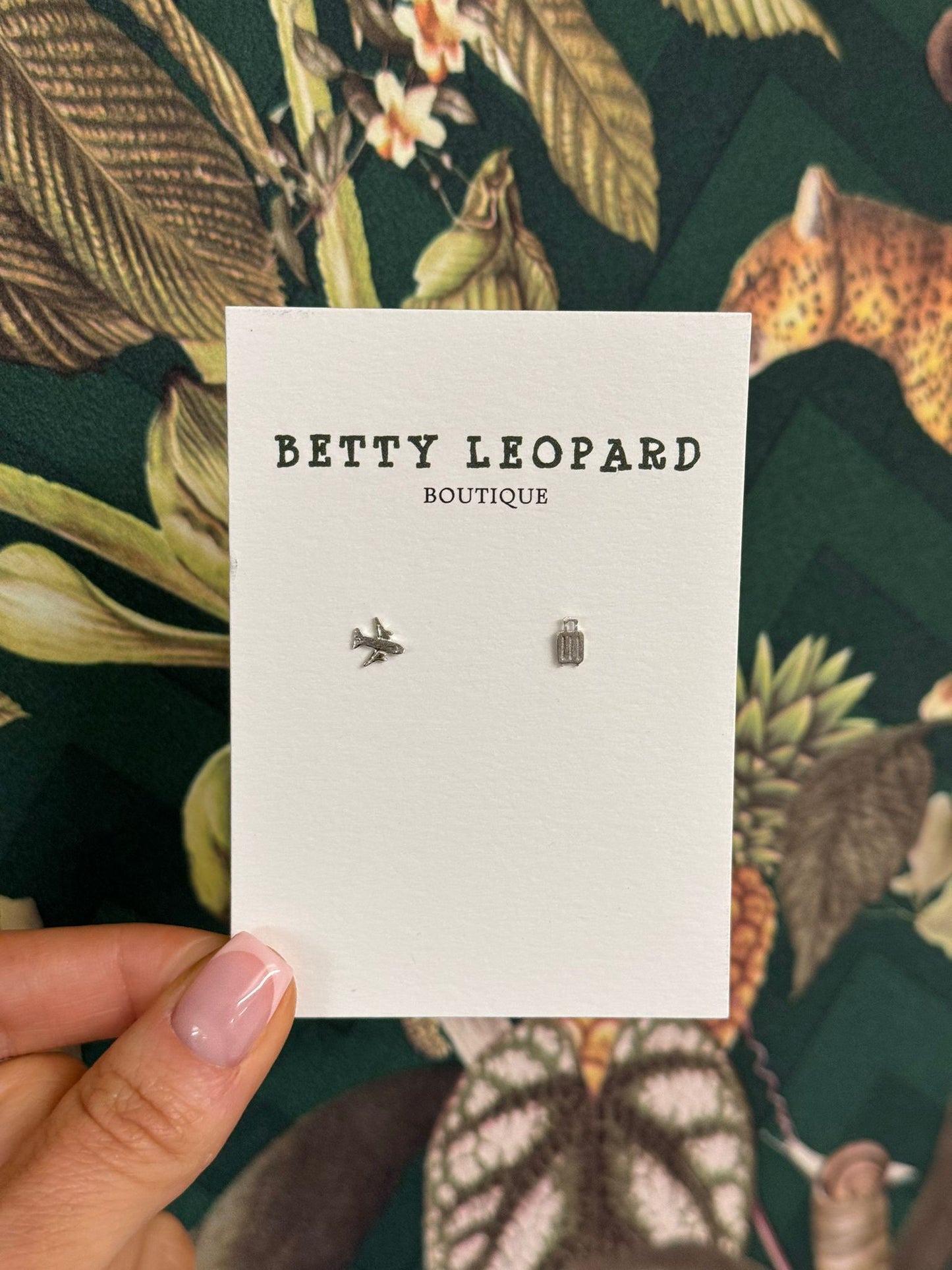 The sterling silver plane and suitcase earrings