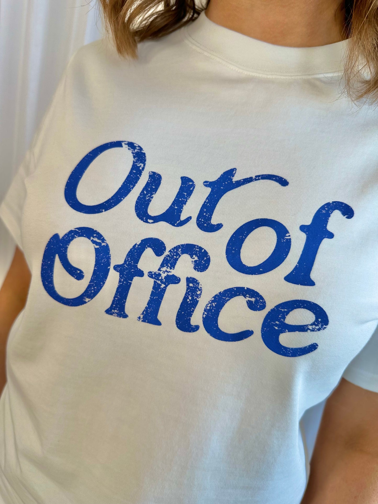 The OUT OF OFFICE white t-shirt with cobalt blue graphic